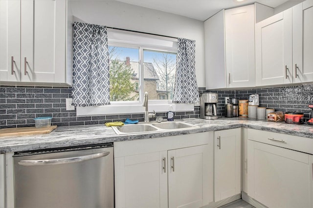 kitchen featuring sink, white cabinets, backsplash, stainless steel dishwasher, and light stone counters