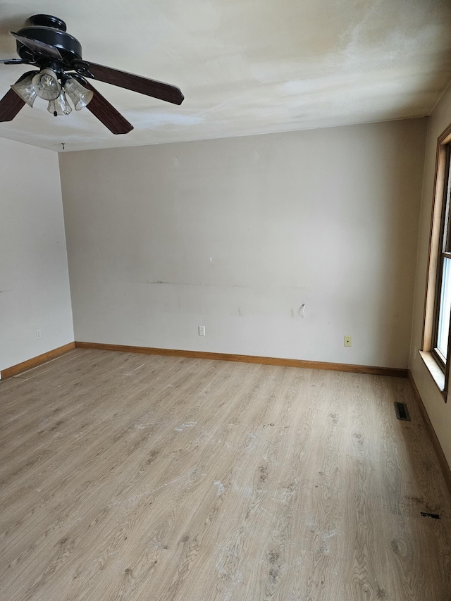 unfurnished room with ceiling fan and light wood-type flooring