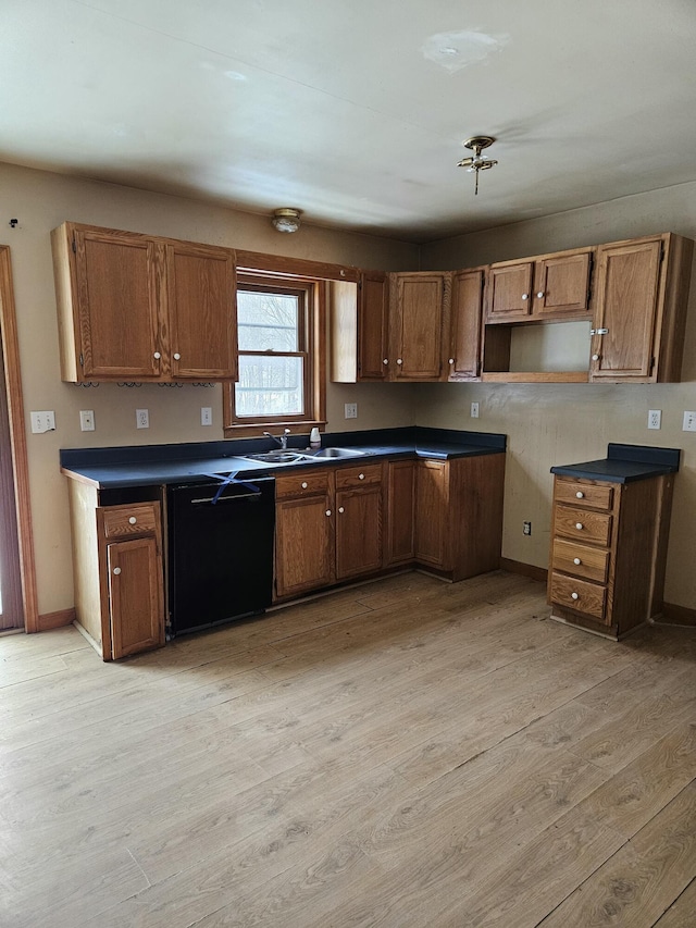 kitchen with dishwasher, light wood-type flooring, and sink