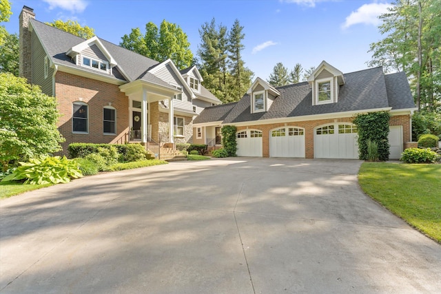 view of front of property featuring a front yard and a garage