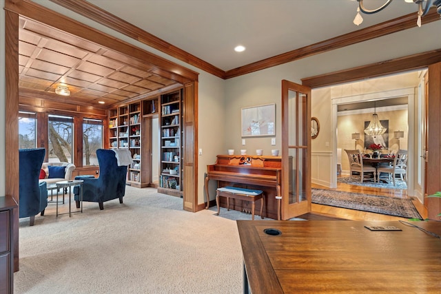 office area with light carpet, ornamental molding, and a notable chandelier