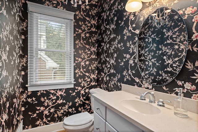 bathroom featuring vanity and toilet