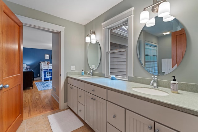 bathroom with tile patterned floors and vanity