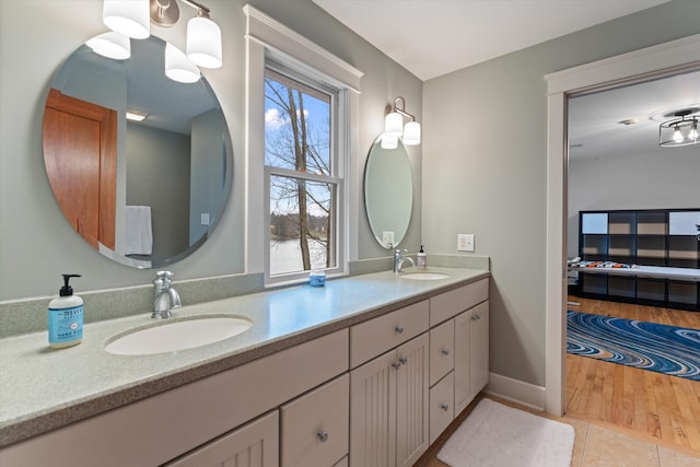 bathroom featuring tile patterned flooring, vanity, and plenty of natural light