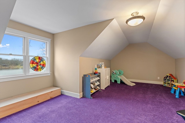 rec room with carpet, a water view, and lofted ceiling