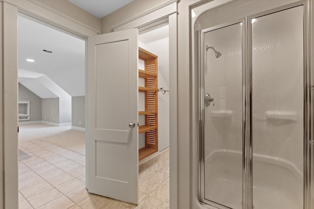 bathroom featuring tile patterned floors, walk in shower, and vaulted ceiling