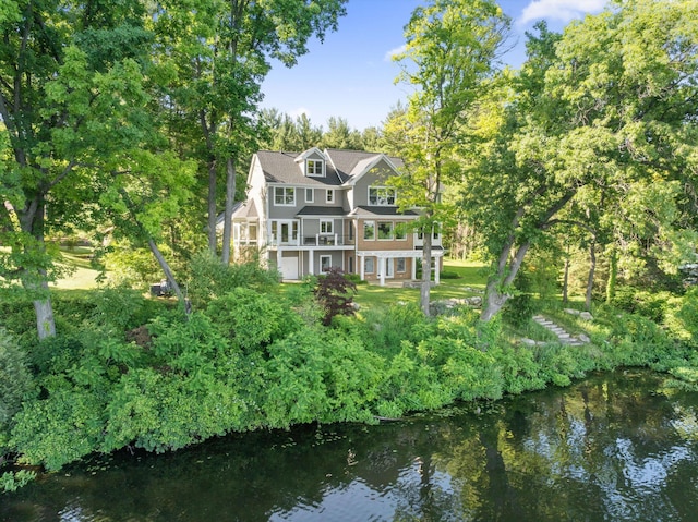 back of house featuring a balcony and a water view