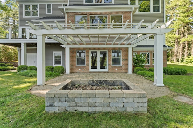 rear view of house with a yard, a pergola, an outdoor fire pit, and a patio area