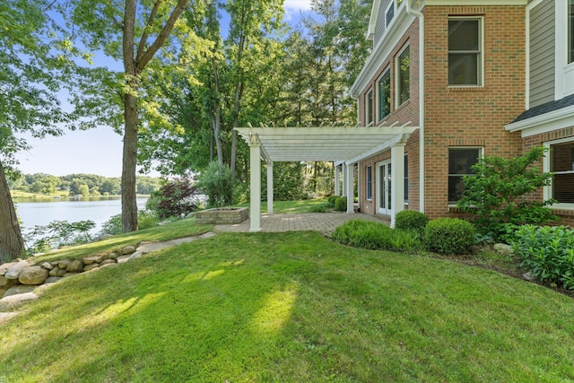 view of yard featuring a pergola, a water view, and a patio area