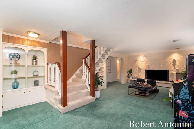 living room with carpet and wood walls