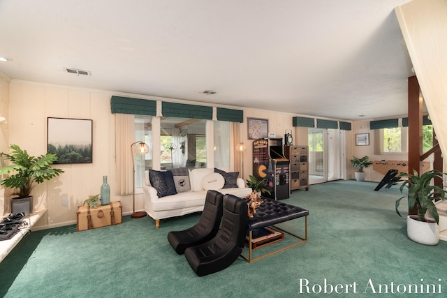 carpeted living room with ornamental molding