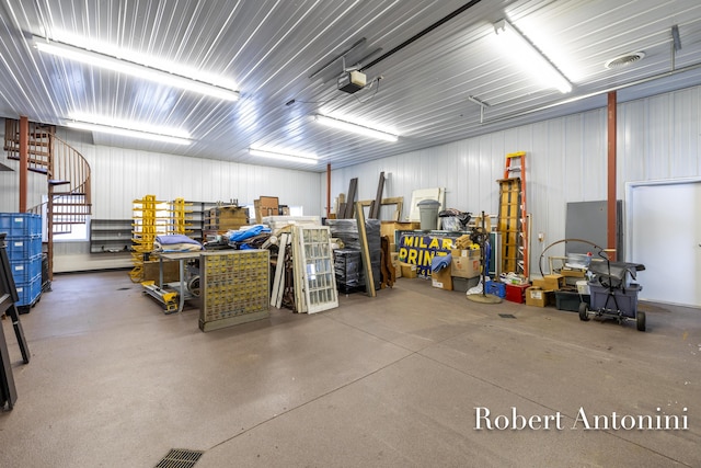 garage with a workshop area and a garage door opener