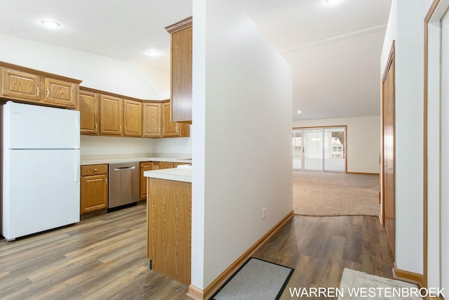 kitchen featuring dishwasher, white refrigerator, and light wood-type flooring