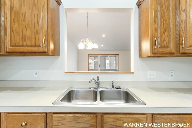 kitchen featuring sink, hanging light fixtures, and a notable chandelier