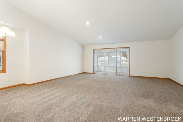 unfurnished room with carpet flooring and lofted ceiling