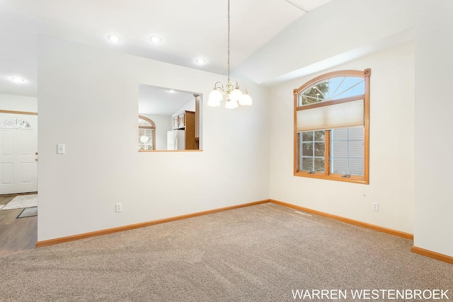 carpeted empty room featuring an inviting chandelier and vaulted ceiling