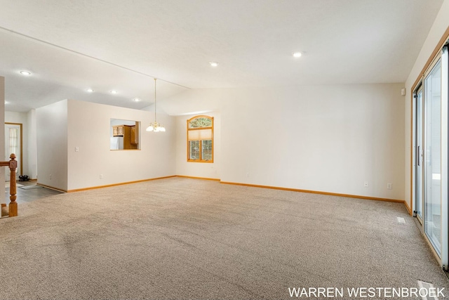 empty room with light colored carpet, vaulted ceiling, and a notable chandelier