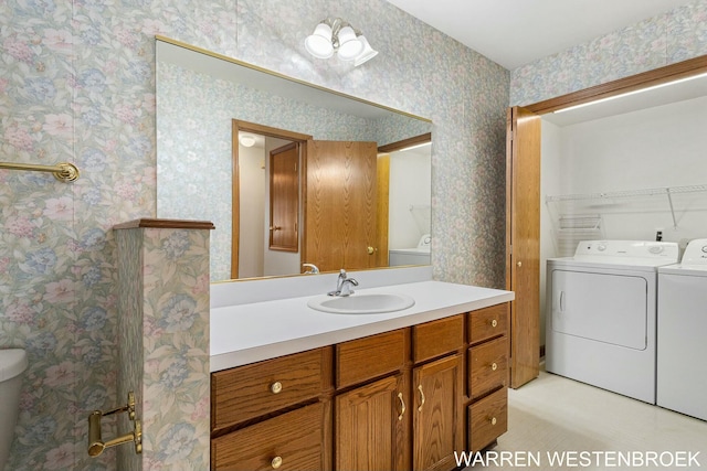 bathroom with separate washer and dryer and vanity