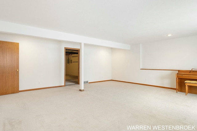 basement featuring light colored carpet