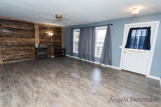 unfurnished living room featuring hardwood / wood-style flooring and ceiling fan