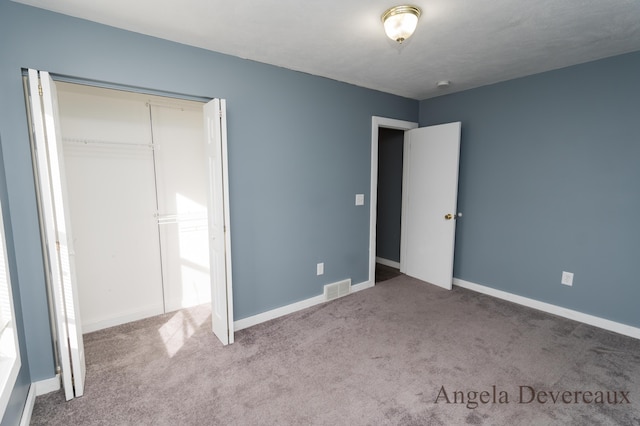 unfurnished bedroom with a closet and carpet