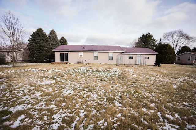 view of snow covered back of property