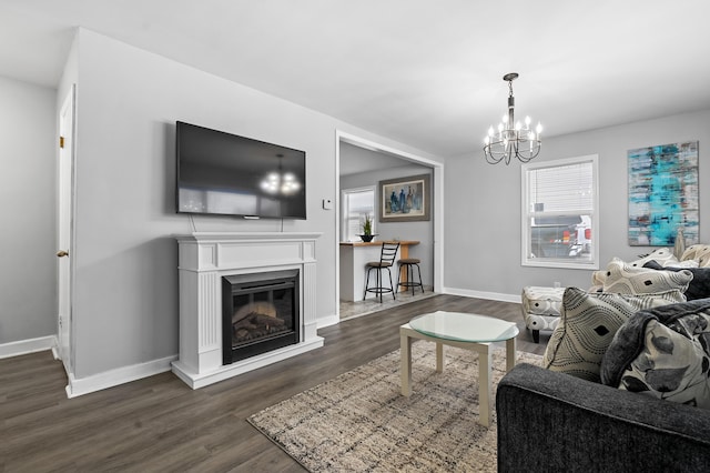 living room with dark hardwood / wood-style flooring and an inviting chandelier