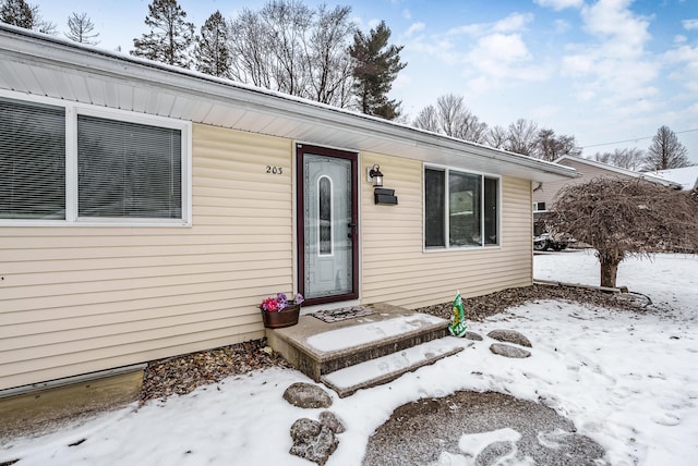 view of snow covered property entrance