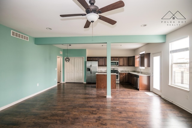 kitchen with ceiling fan, sink, dark hardwood / wood-style flooring, dark brown cabinets, and appliances with stainless steel finishes