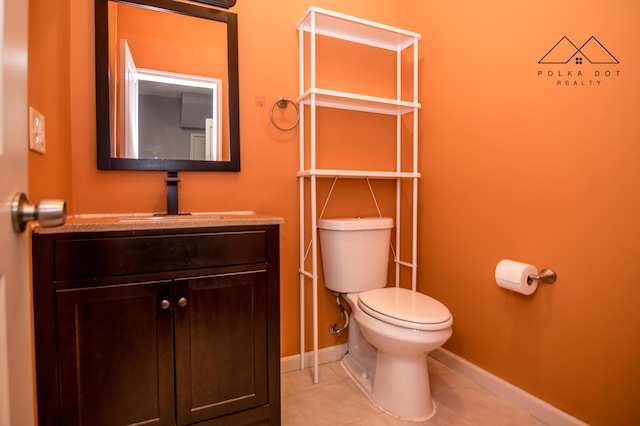 bathroom featuring tile patterned floors, vanity, and toilet