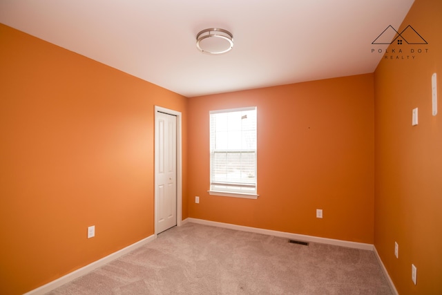 empty room with light colored carpet