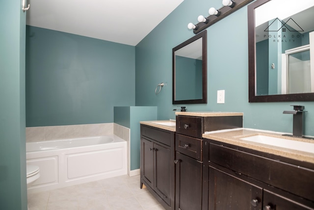 bathroom featuring tile patterned flooring, a bathtub, toilet, and vanity