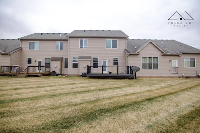 rear view of property featuring a lawn, central AC, and a wooden deck