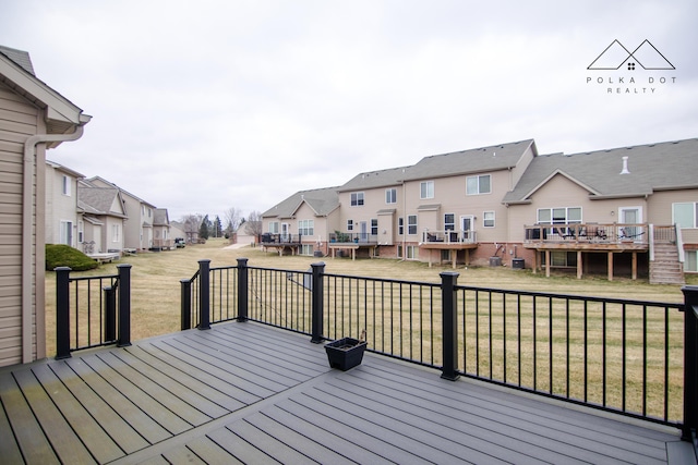 wooden deck with a lawn