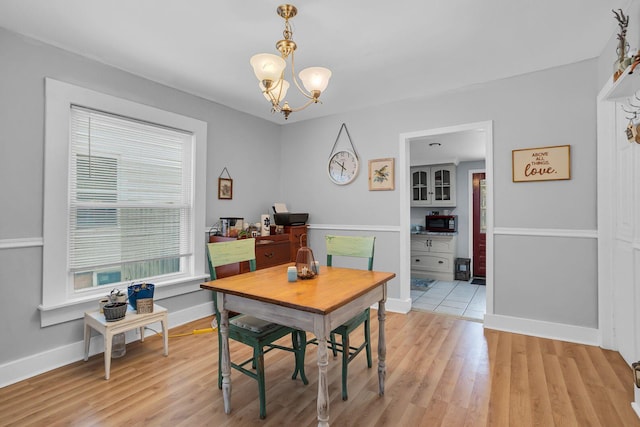 dining area with a chandelier and light hardwood / wood-style floors