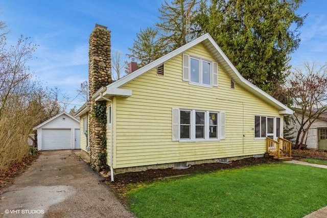 view of side of home featuring an outbuilding, a yard, and a garage