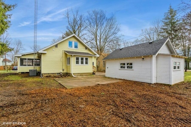 rear view of house with central AC unit, a sunroom, and a patio