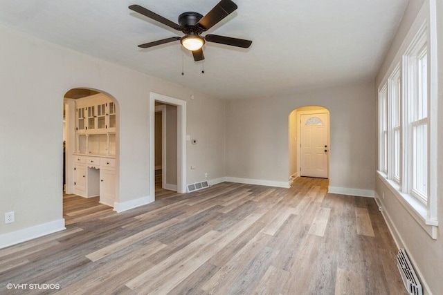 spare room featuring light hardwood / wood-style flooring and ceiling fan