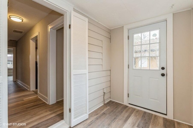 entryway with hardwood / wood-style floors