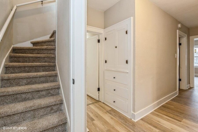 stairs with hardwood / wood-style floors