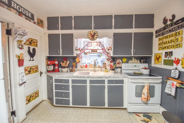 kitchen with white range with electric stovetop and sink