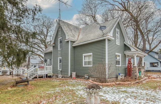 view of side of property featuring a yard and a wooden deck