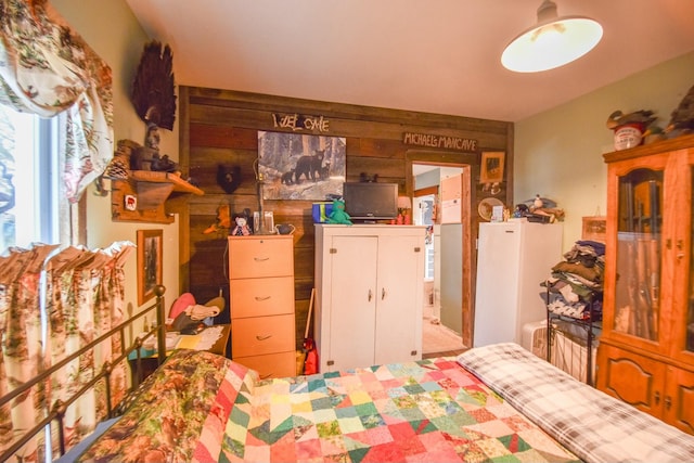 bedroom with wood walls