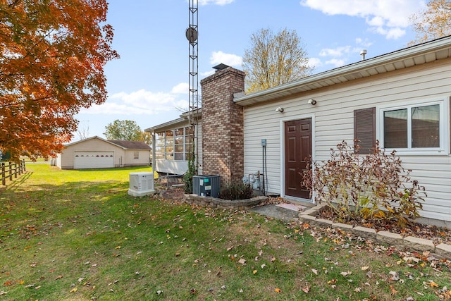 exterior space with central air condition unit and a yard