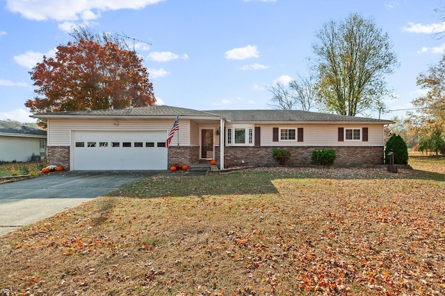 single story home with a front yard and a garage