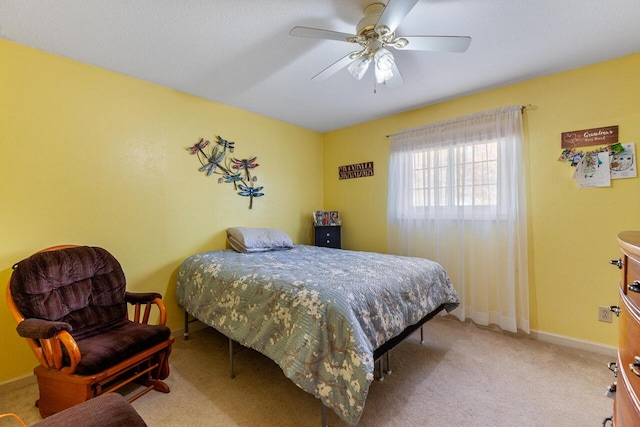 bedroom with ceiling fan and light colored carpet