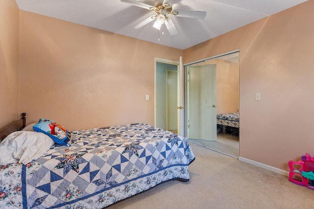 bedroom featuring ceiling fan, a closet, and light carpet