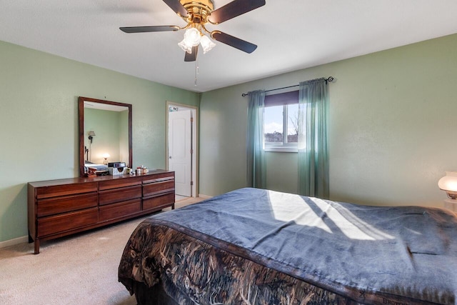 bedroom with light carpet and ceiling fan