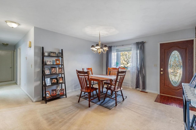 carpeted dining area featuring a notable chandelier