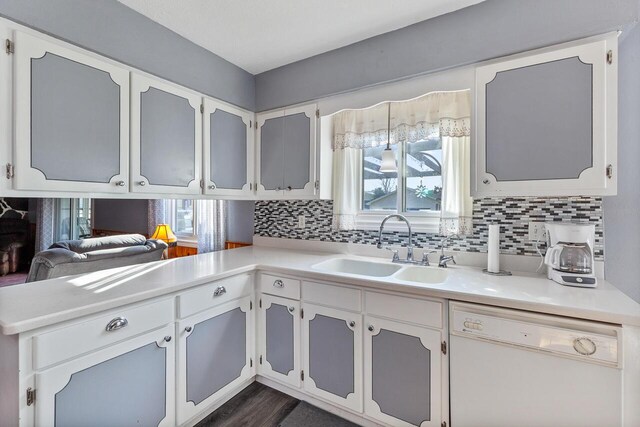 kitchen featuring dishwasher, white cabinetry, plenty of natural light, and sink